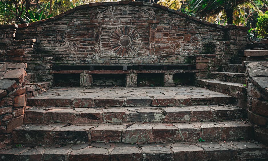 A beautifully crafted stone bench and steps in a rustic garden setting, perfect for tranquil moments.