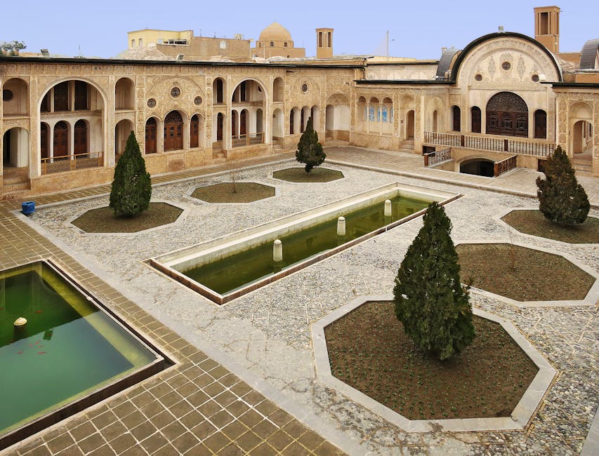 A traditional Persian courtyard featuring stunning architecture, arched windows, and serene fountains, capturing cultural splendor.